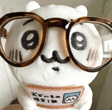 a stuffed animal wearing glasses and a patch that says " o " on it