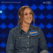 a woman wearing a denim jacket has a name tag that says keirstin