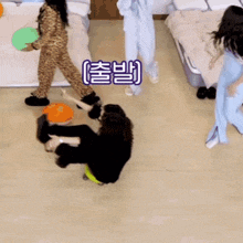 a group of women are playing with a ball in a room with chinese writing on the wall