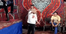 a man with the number 9 on his shirt is dancing