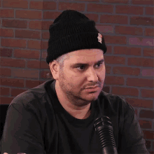 a man wearing a black beanie says right