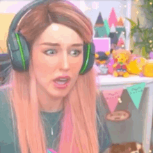 a woman wearing headphones is making a funny face .