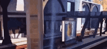 a train is pulling into a train station with stairs and a bench .