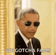 barack obama is wearing sunglasses and peeking out from behind a wall .