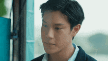 a close up of a young man 's face with a serious look on his face