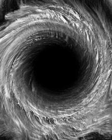 a black and white photo of a swirl with a black background