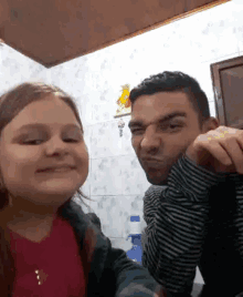 a man and a little girl are looking at the camera and smiling