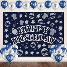 a happy birthday backdrop with blue and white balloons and footballs .