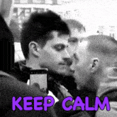 a man taking a picture of another man with the words " keep calm " above him