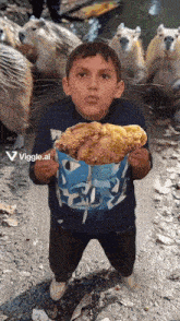 a young boy is holding a bag of fried chicken in front of some capybaras