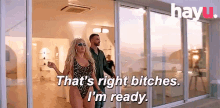 a woman in a bathing suit says that 's right bitches i 'm ready while walking with a man