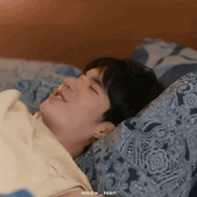 a man is laying on a bed with his eyes closed and the name meow_keen is on the bottom of the picture