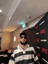 a man standing in front of a ufc banner