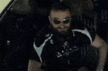 a man with a beard wearing sunglasses and a shirt that says npa on it
