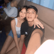 a man and woman are posing for a picture together