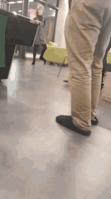 a woman standing in a room with a green table