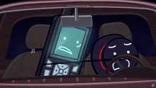 a cell phone with a sad face on it is sitting in a car