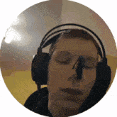 a man wearing headphones with his eyes closed and a microphone sticking out of his nose