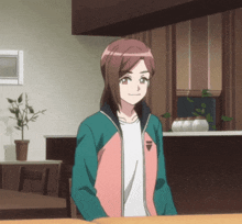 a girl in a pink and green jacket with the letter i on the front