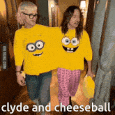 two people wearing yellow shirts with spongebob faces on them are walking down a hallway .