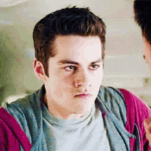 a close up of a young man 's face while looking at another man .