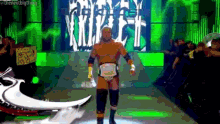 a wrestler is walking down a runway with a sign that says the next big thing on it