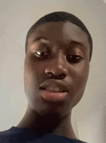 a close up of a young man 's face making a funny face