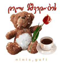 a teddy bear with a flower and a cup of coffee