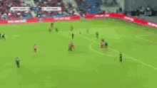 a blurred image of a soccer field with players on it