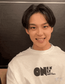 a young man wearing a shirt that says one