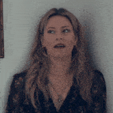 a woman with a surprised look on her face is wearing earrings and a necklace