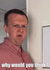a man in a red shirt is standing in front of a white board and asking why would you think ?
