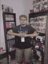 a man wearing a hurley t-shirt stands in front of a bookshelf