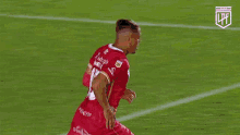 a soccer player in a red jersey with the number 15 on it