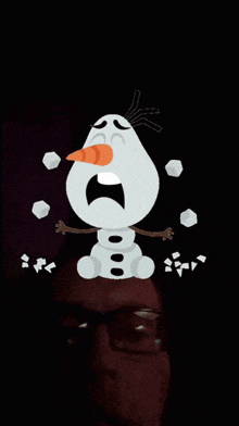 a man wearing glasses stands in front of a snowman that looks like olaf from frozen