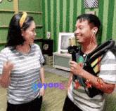 a man and a woman are standing next to each other with the word goyang written on the bottom