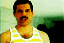 a man with a mustache wearing a white and yellow tank top