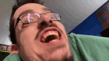 a man wearing glasses is making a funny face