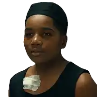 a young boy with a bandage on his chest is wearing a black hat