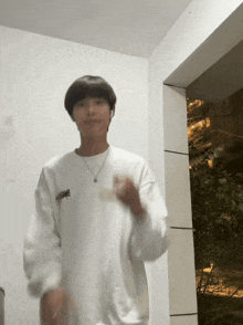 a young man wearing a white sweatshirt with the word snoopy on the front