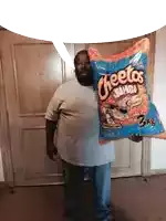 a man holds up a bag of cheetos jumbo