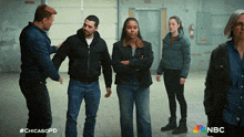 a group of people standing next to each other with a chicagopd logo on the bottom