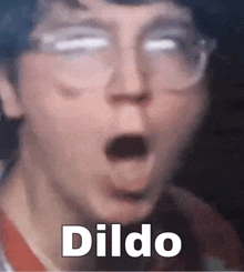 a close up of a person 's face with a surprised look on his face and the word dildo written on it .