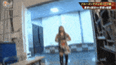 a female wrestler is standing in a hallway with a sign that says #stardom