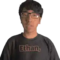 a young man wearing glasses and a shirt that says ethan