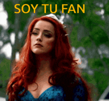 a woman with red hair and the words soy tu fan on the bottom