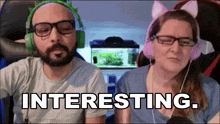 a man and a woman wearing headphones and cat ears are sitting next to each other and the woman says interesting .