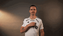 a man wearing a white shirt that says scandic
