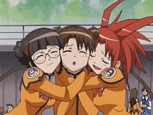 three anime girls are hugging each other and one of them has a skull on her sleeve