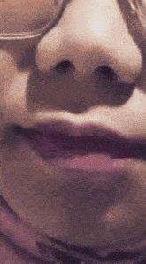a close up of a woman 's face with glasses on